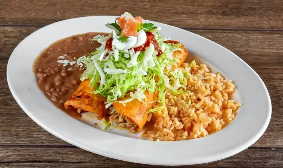 Enchiladas topped with sauce and cheese