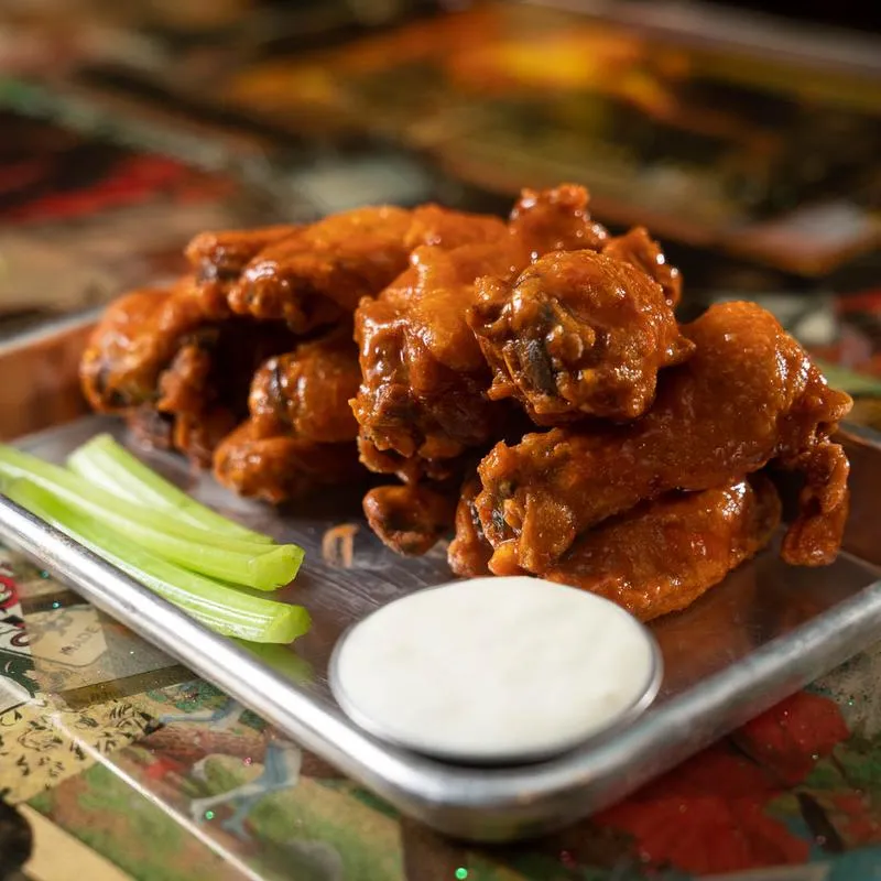 Wings served with celery and a sauce dip