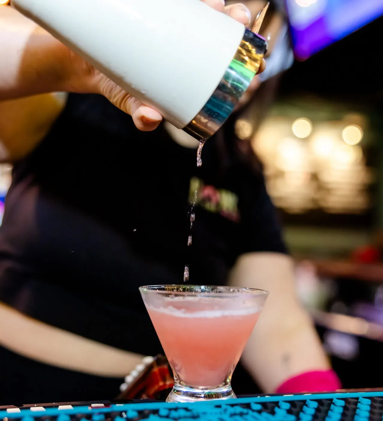 Bartender pouring a handcrafted cocktail during Orlando Happy Hour at Howl at the Moon.