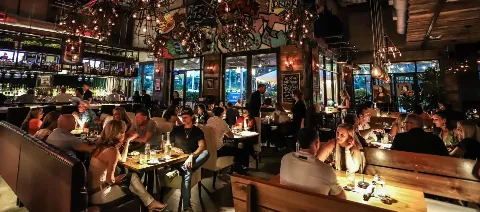 Interior of Mia Kitchen & Bar at Night with Guests