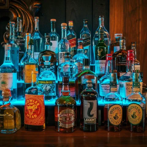 Assorted liquor bottles on bar shelves