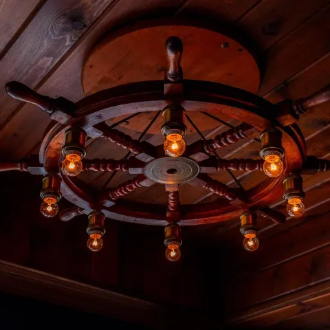 Interior, a vintage nautical ship wheel chandelier.