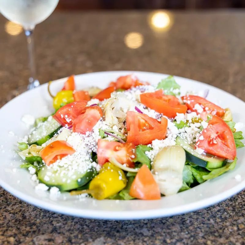 Greek salad with tomato, cucumber, and feta cheese.