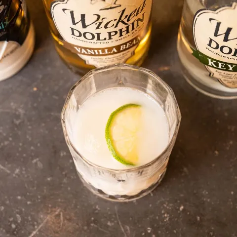Key Lime Pie cocktail, alongside couple bottles of rum.