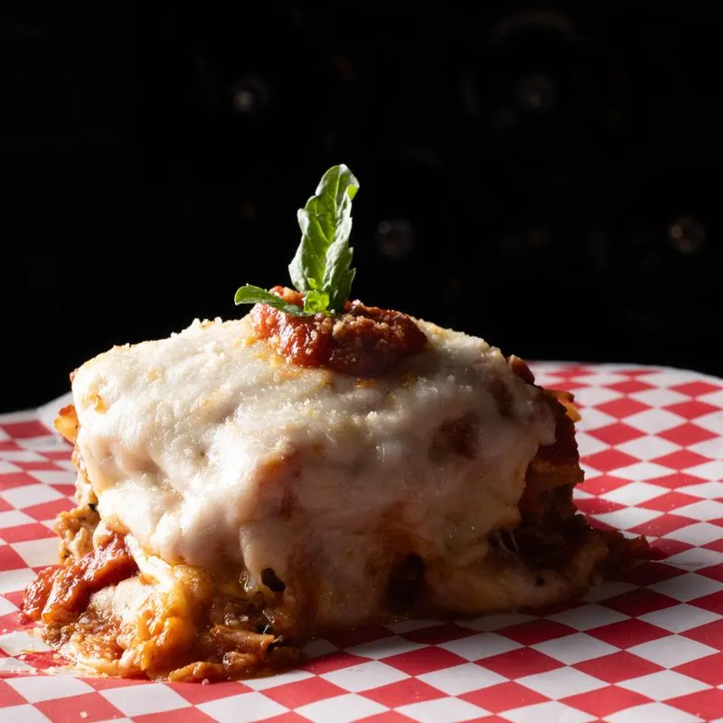 Lasagna pasta topped with melted cheese and basil.