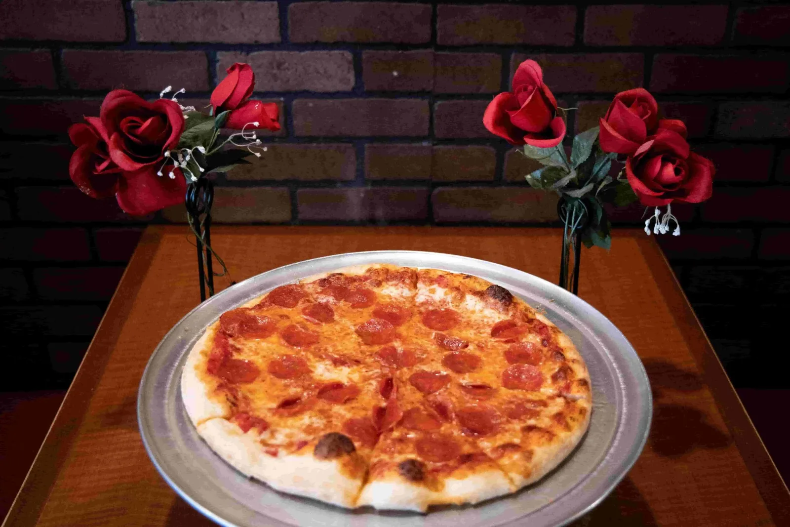 Pepperoni pizza with rose table decorations