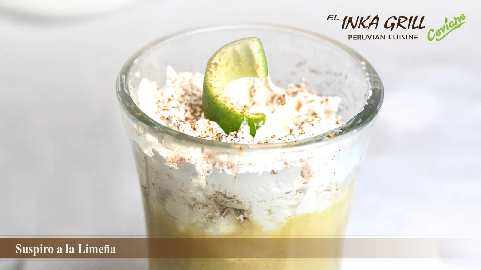 A glass of ice cream with lime and whipped cream.