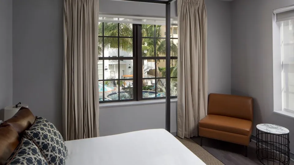 A Bedroom With A Large Window
