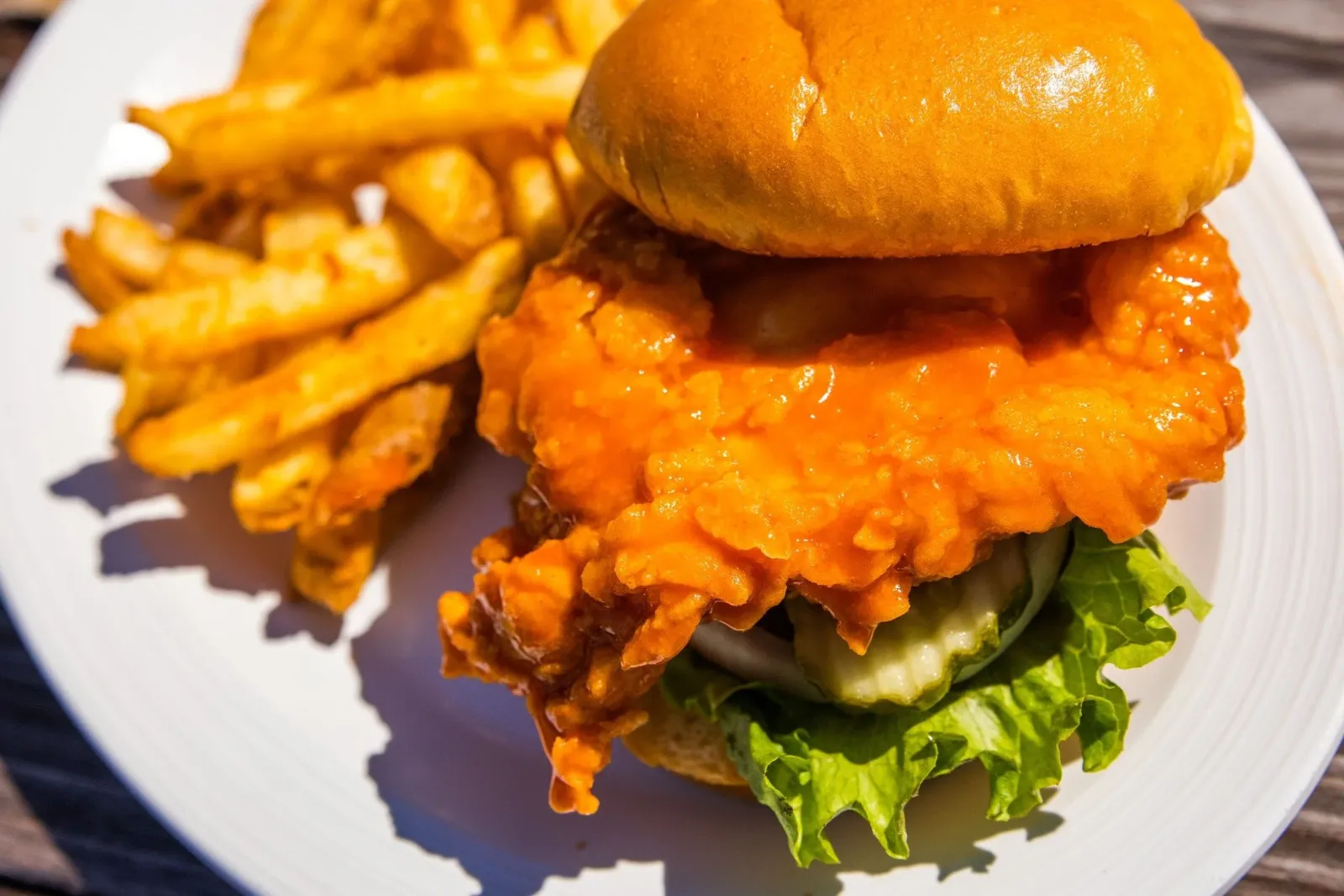 🔥 Craving the perfect combo? 🔥

Feast your eyes on our crispy, juicy chicken sandwich smothered in spicy buffalo sauce, served with golden fries! 🍗🍟

Whether you're looking for a spicy kick or the