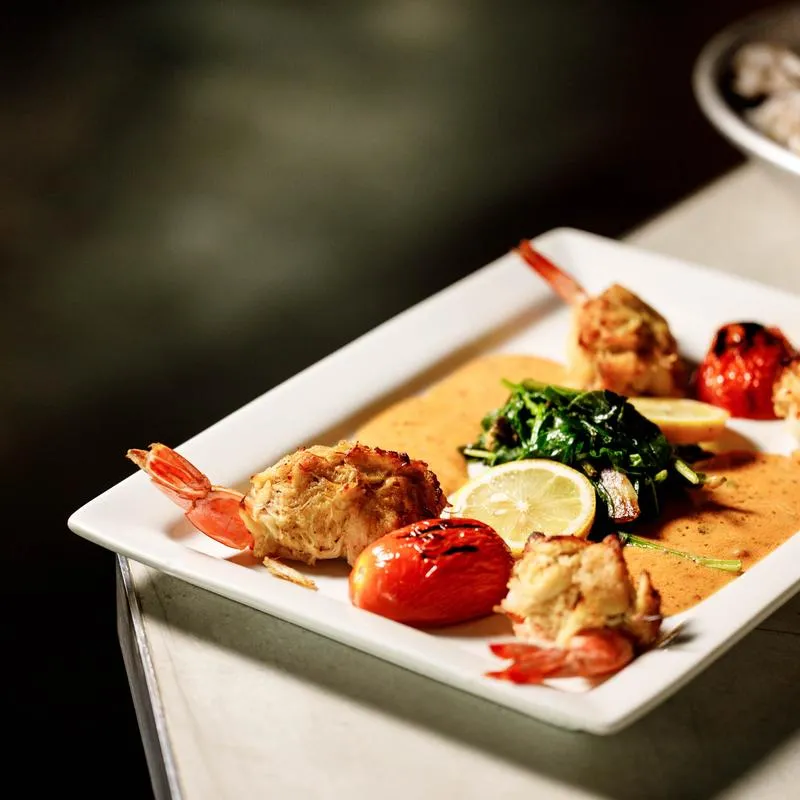 Shrimp stuffed with crab meat and lobster sauce.