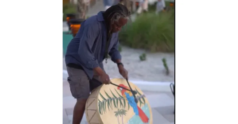 A Man Carrying A Surfboard