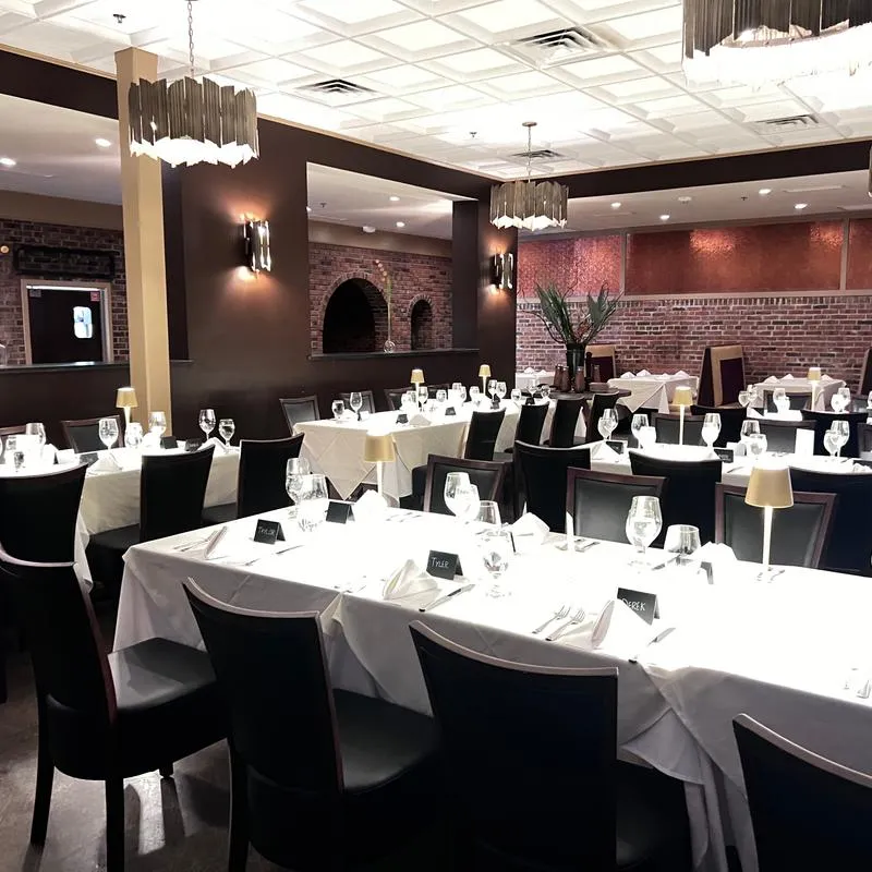 Dining room tables decorated and set up for a wedding.