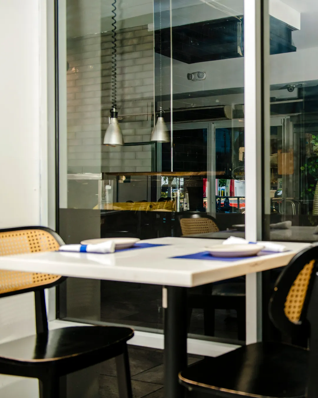Acropolis_Kennedy_WindowTable_CaneChairs