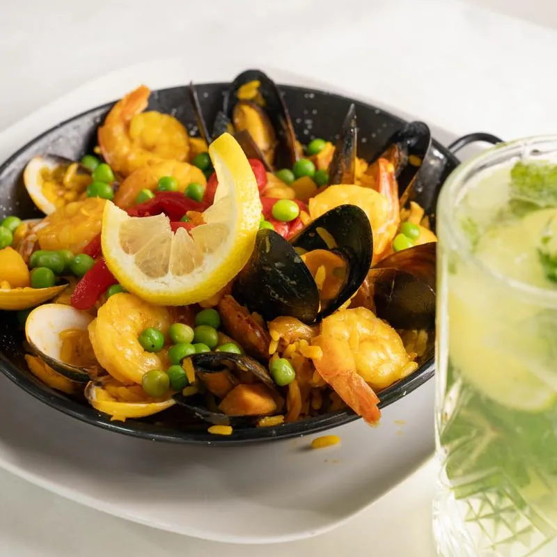 Paella Valenciana accompanied with a Mojito.