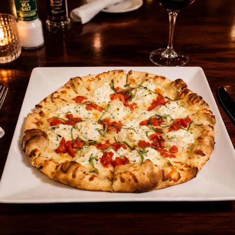 White Pizza, with mozzarella, ricotta cheese, basil, and tomatoes.