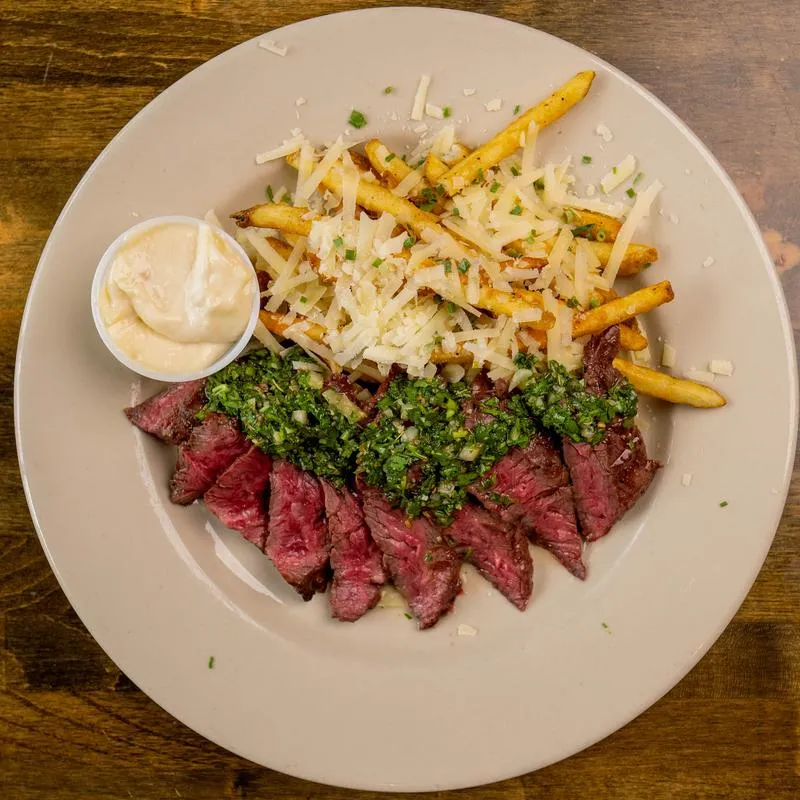 Steak chimichurri with side fries.