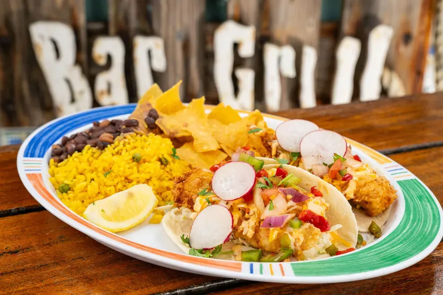 Our famous Baja-style tacos with yellow rice, black beans, and chips