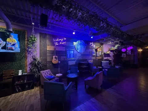 Neon 'Welcome to The Moon' lounge seating at Moon Mountain kava lounge in Brandon FL