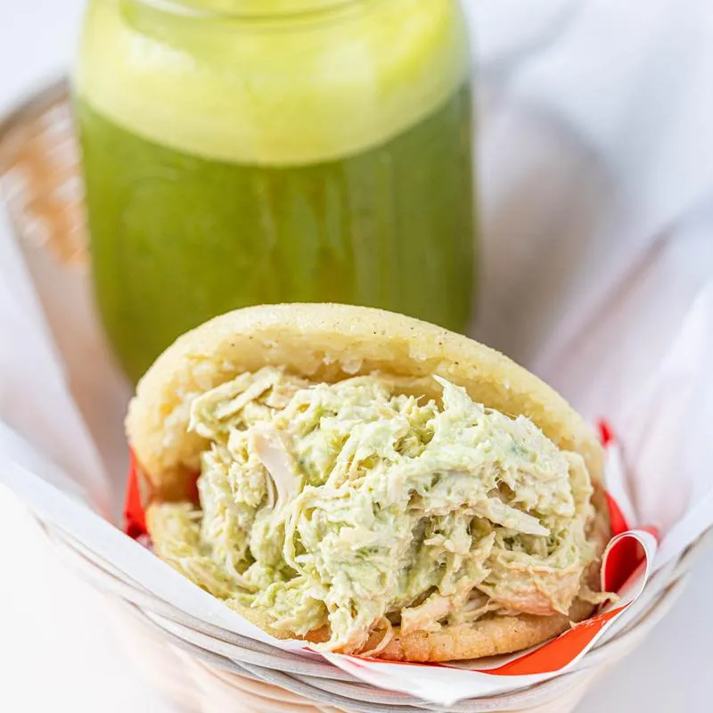 Arepa with chicken and avocado salad.