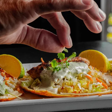 Ahi tuna tacos are garnished with cilantro.