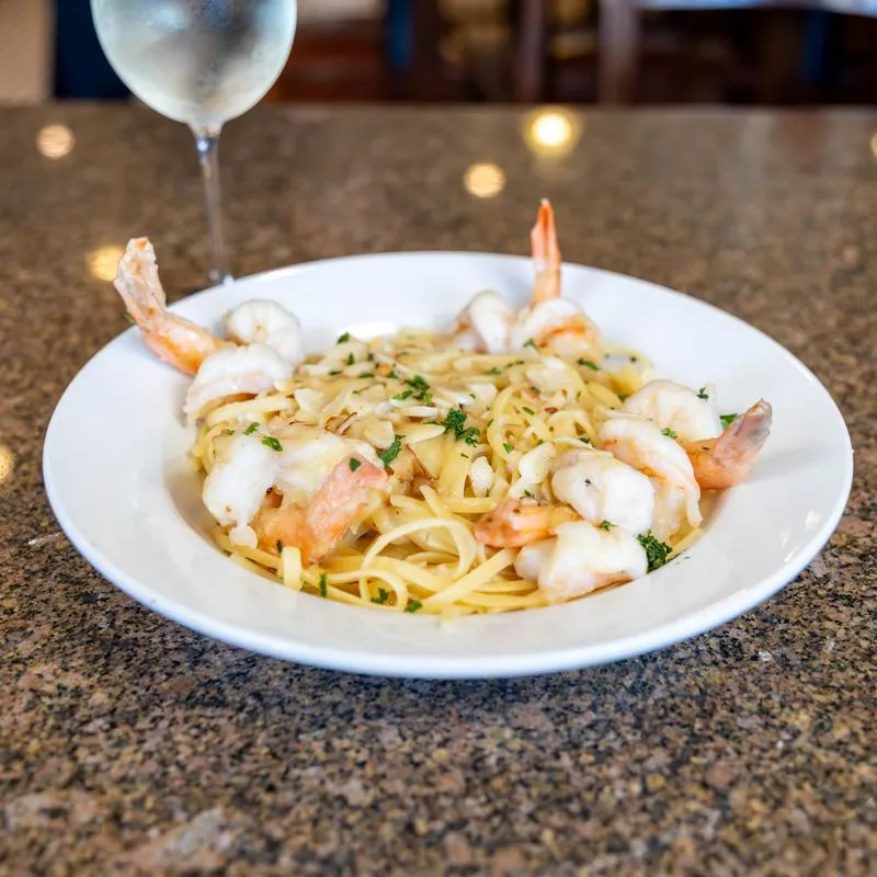 Shrimp scampi pasta served on a white plate.
