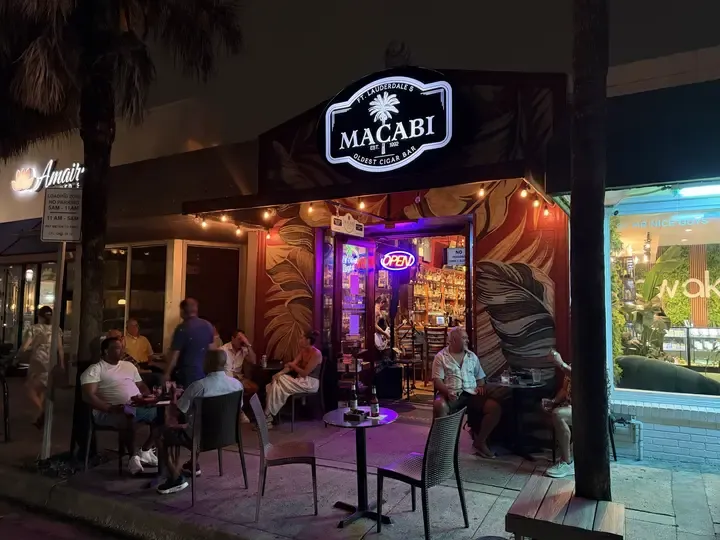 Guests enjoying the outdoor seating at Macabi Cigar Bar at night