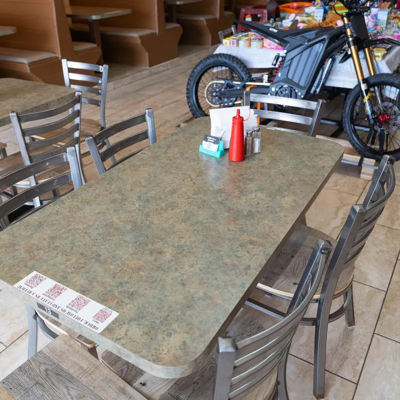 Restaurant table by the electric bicycle.