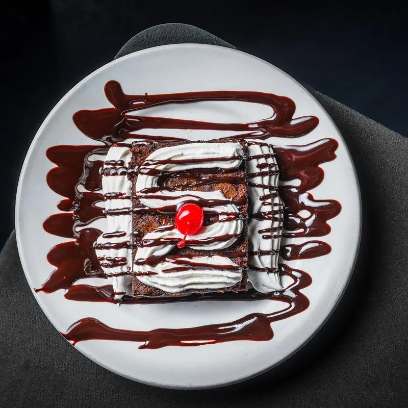 Chocolate cake dessert on a plate, top view.