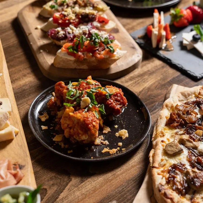 Various prepared dishes served on wooden boards