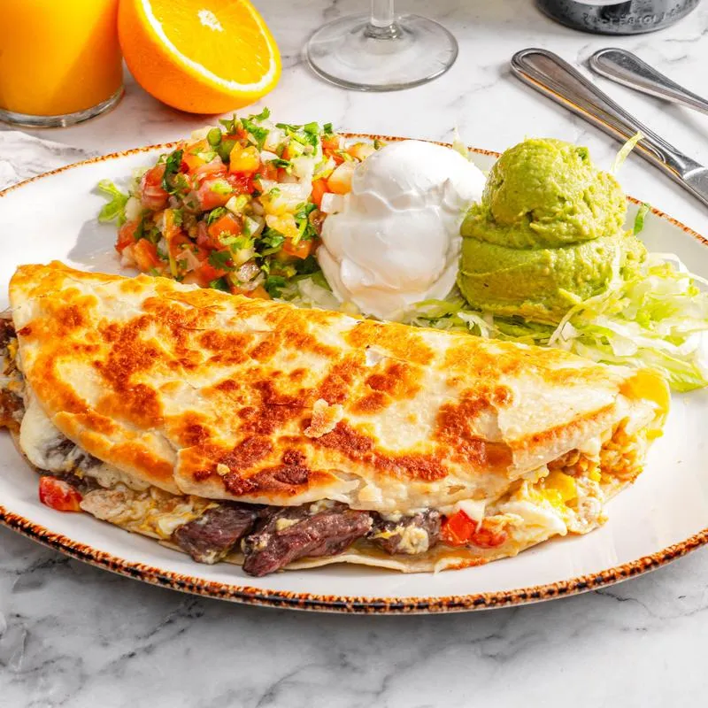 Brunch Quesadilla served with guacamole, sour creame and pico de gallo.