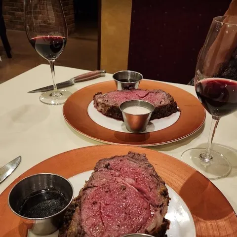Restaurant table with two prime rib dinners..