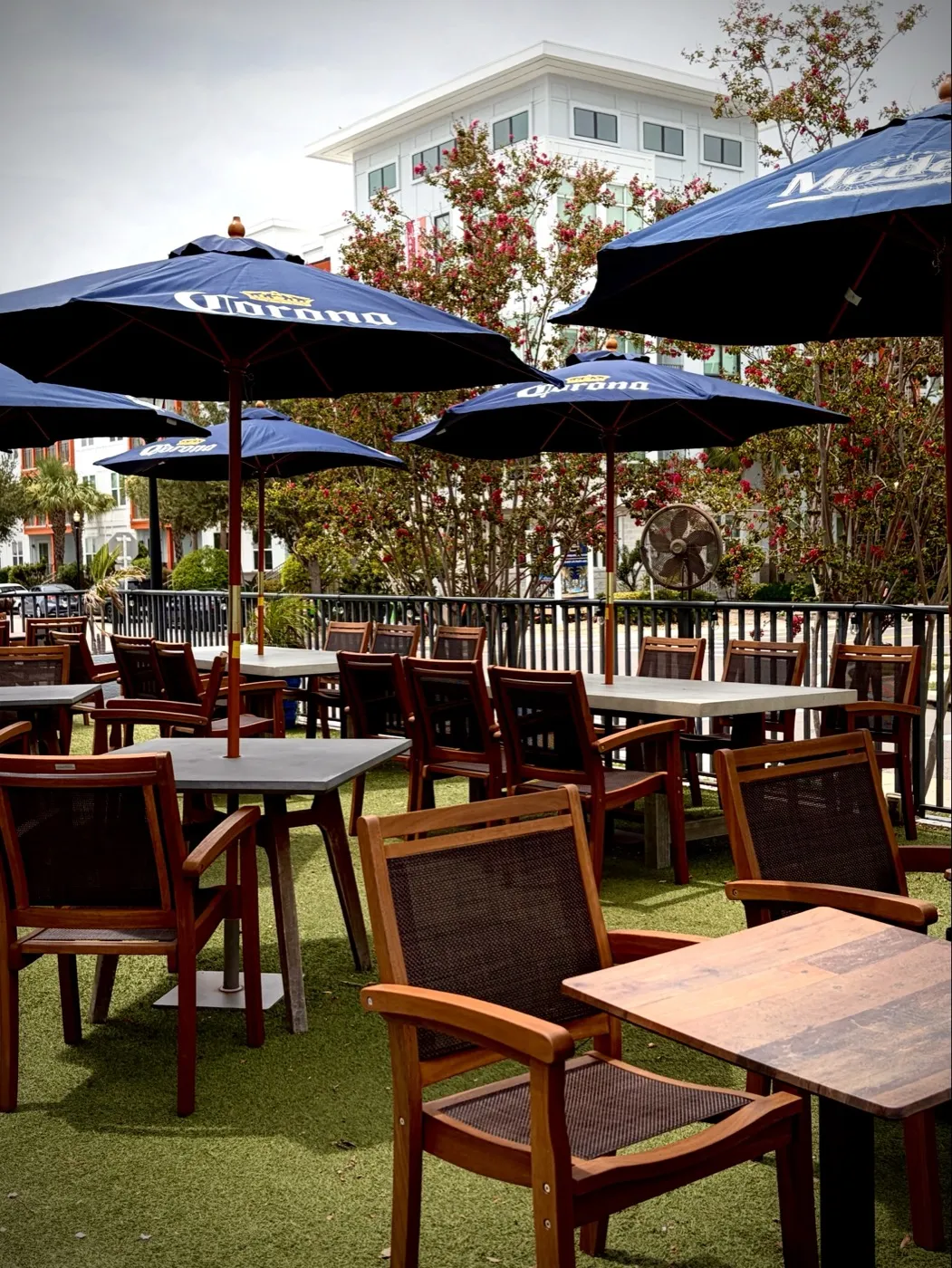The City Dog Cantina patio with Corona umbrellas, turf, and shaded tables