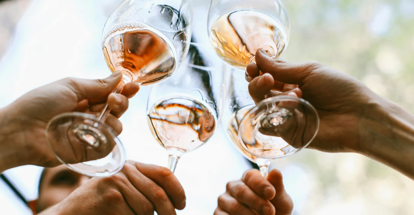 A Group Of Hands Holding Wine Glasses