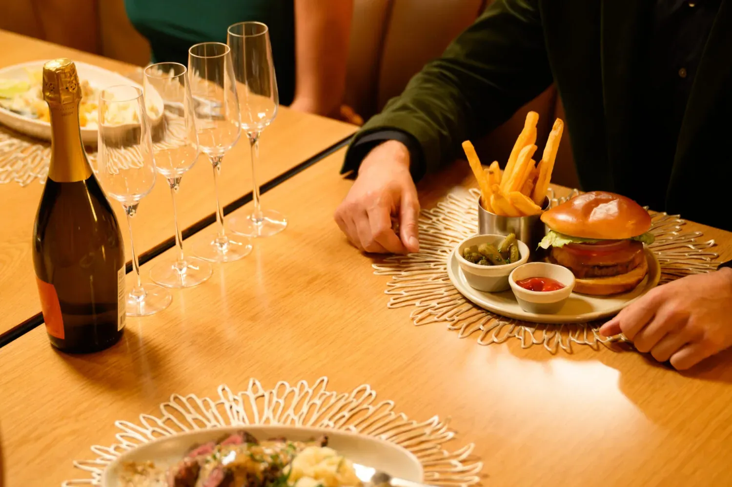 Table set with champagne, glasses, and small plates in a restaurant