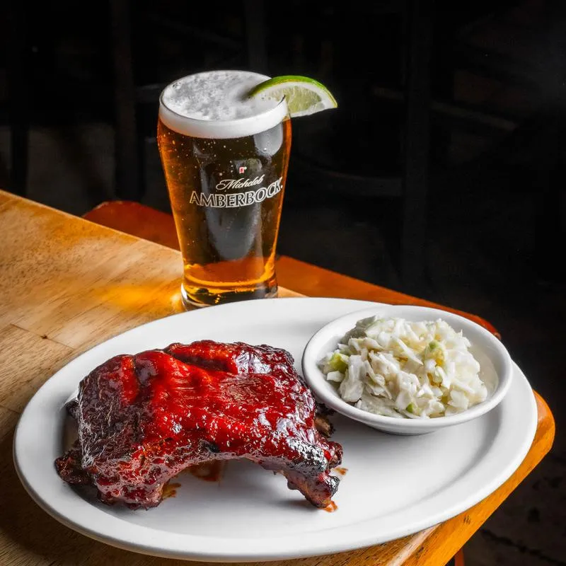 BBQ ribs with coleslaw and a glass of beer.