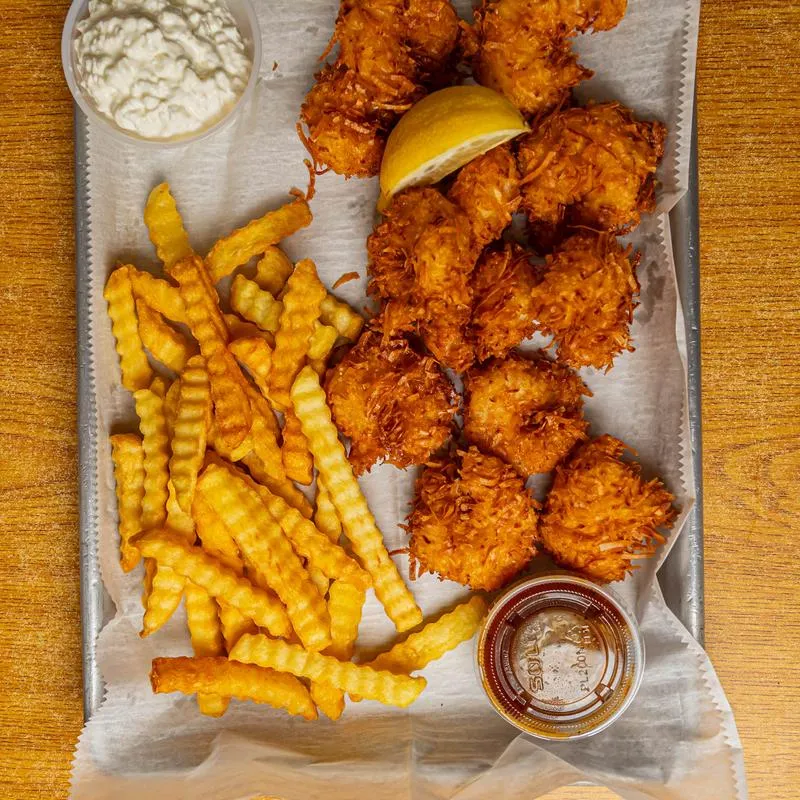 Coconut shrimp served with crinkle cut fries and dipping sauces.