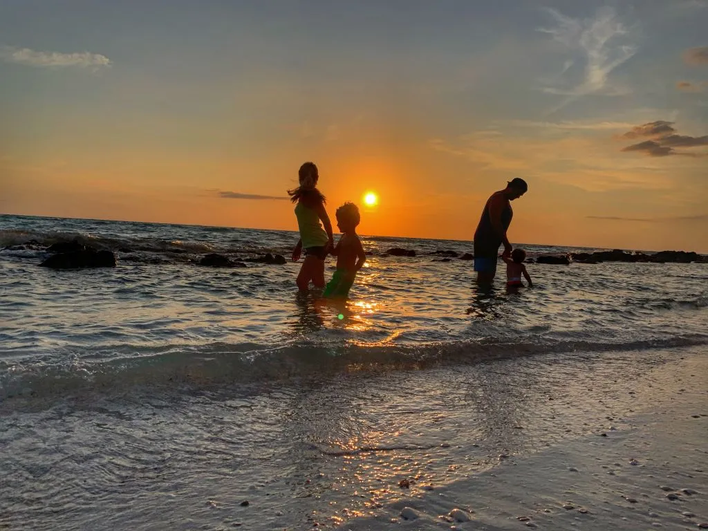 A Couple Of People That Are Walking On The Beach