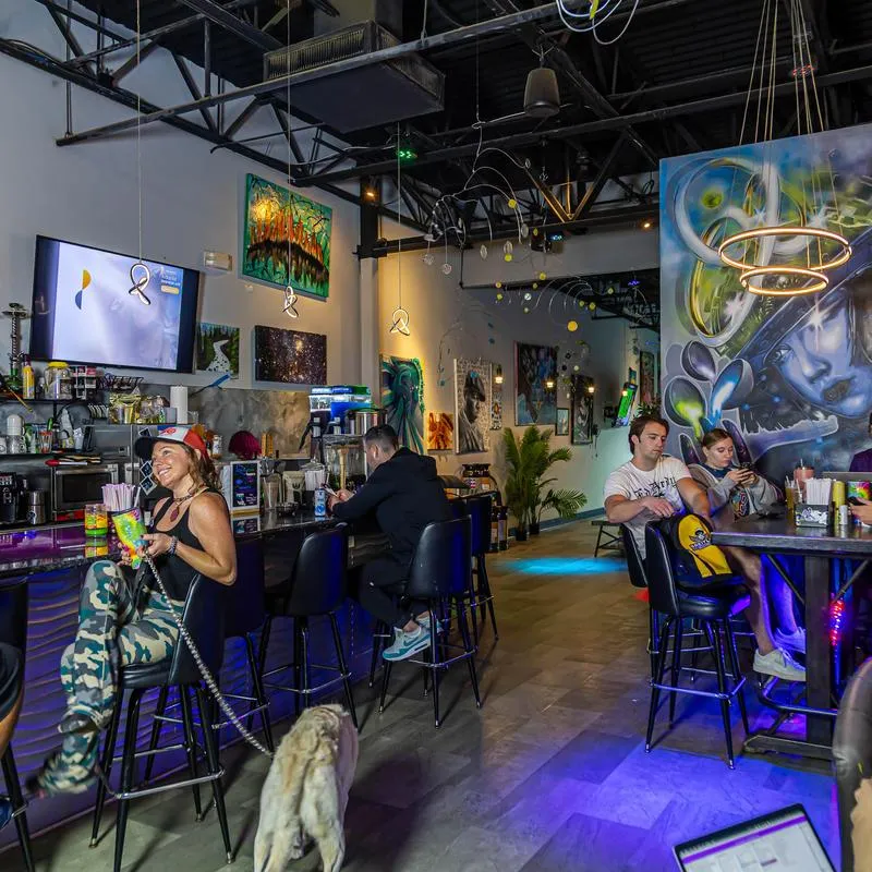 Interior with high ceilings with exposed structural beams and artistic wall murals.