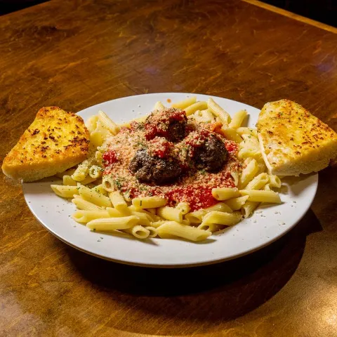 Plate with meatballs pasta on the table.