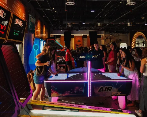 Arcade room showing an air hockey table and skee ball machines.