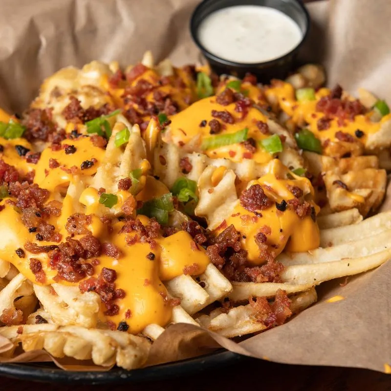 Loaded Waffle Fries with a sauce dip