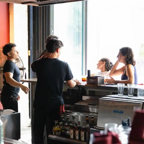 Bartender tending to customers.