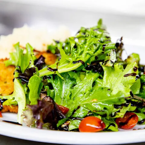 Fried chicken salad, with lettuce, tomato, and balsamic.