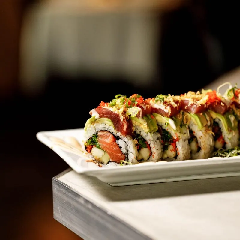 Sushi rolls with salmon, cucumber, seaweed, tuna, avocado, tempura flakes, and roe.