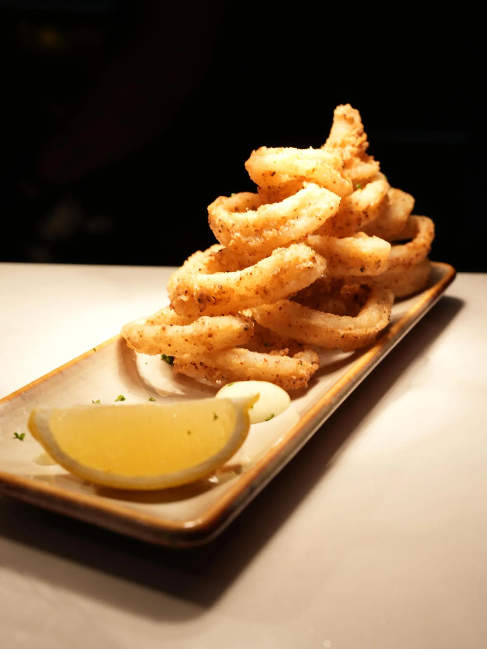 Crispy fried calamari served with lemon and aioli at Madrid Tapas y Vinos