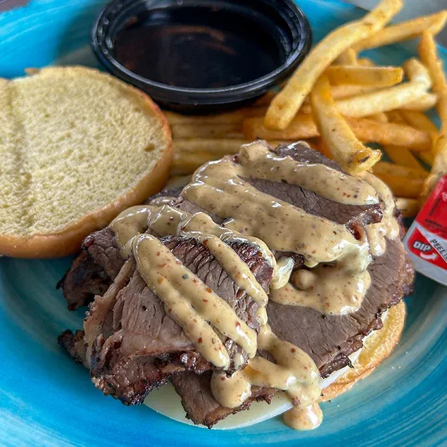 Slow smoked Beef Brisket with provolone cheese & brew pub mustard. Served on toasted brioche roll with a side of our onion & mushroom au jus.