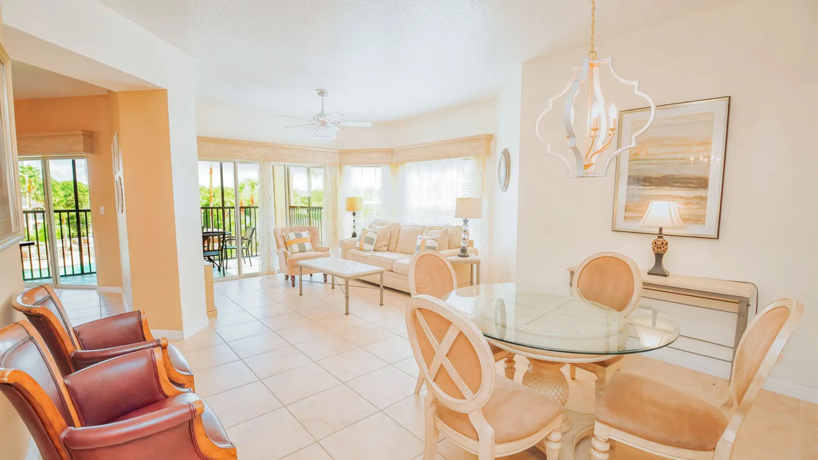 a room with a table chairs and a chandelier
