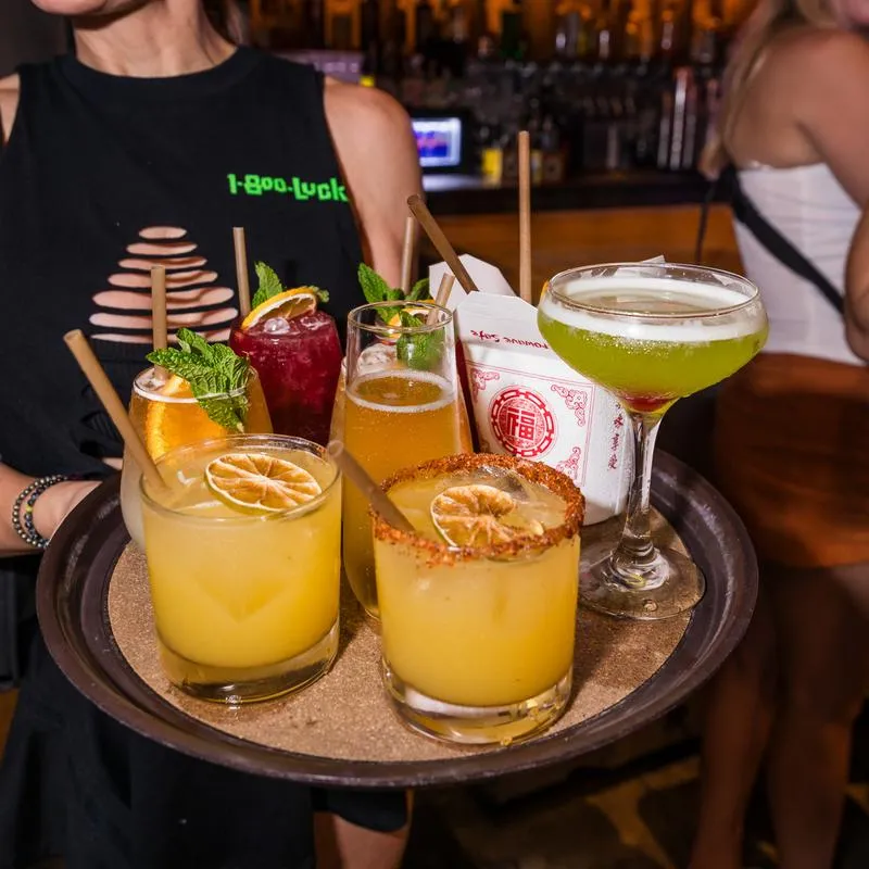 A tray with various drinks and food.