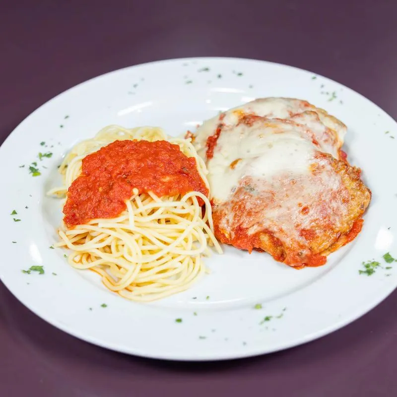 Chicken Parmesan served with spaghetti in marinara sauce.