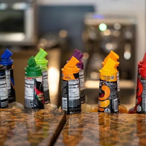 Assorted cocktail mix bottles at the bar.